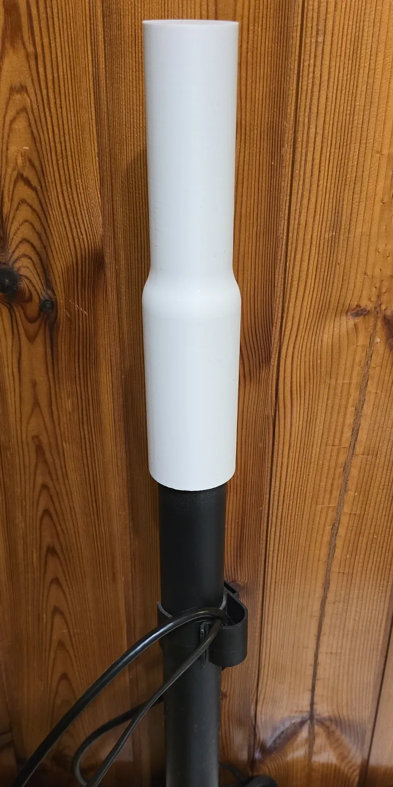 The white printed extension fitted over the top of the black steel pole