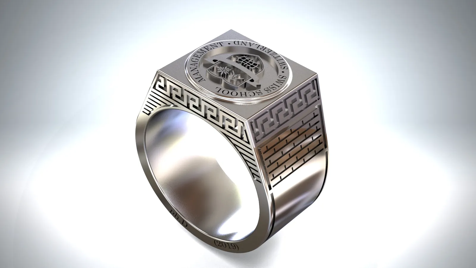 Render di un anello di laurea con l'emblema di un istituto in rilievo, bordi a greca e spalle con motivo a mattoni